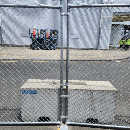 Security Fencing can be held by concerete blocks or smaller orange weights depending on wind load